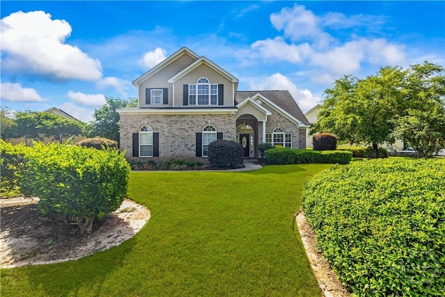 303 Stonebridge Cir, Savannah, GA 31419 - traditional-style house with brick siding and a front lawn