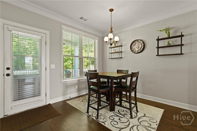 119 Greystone Dr, Guyton, GA 31312 - dining room featuring healthy amount of natural light, baseboards, ornamental molding, dark wood-style flooring, and a chandelier