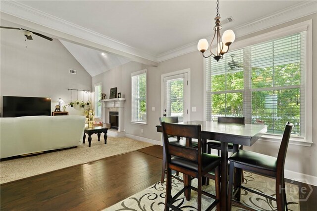 119 Greystone Dr, Guyton, GA 31312 - dining area featuring hardwood / wood-style flooring, a fireplace with raised hearth, lofted ceiling, ceiling fan, and baseboards