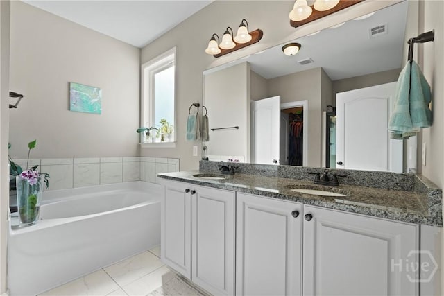 119 Greystone Dr, Guyton, GA 31312 - full bath with marble finish flooring, a garden tub, double vanity, and a walk in closet