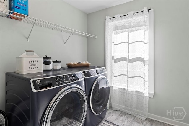 216 Cypress Lakes Dr, Bloomingdale, GA 31302 - washroom featuring washing machine and clothes dryer, plenty of natural light, wood finished floors, and baseboards