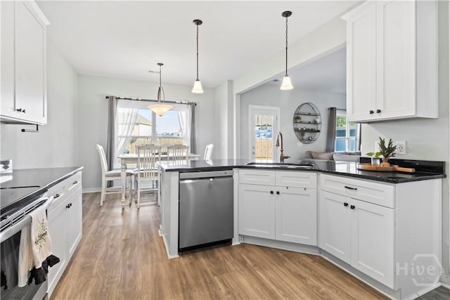 216 Cypress Lakes Dr, Bloomingdale, GA 31302 - kitchen featuring stainless steel appliances, a sink, light wood-type flooring, and dark countertops