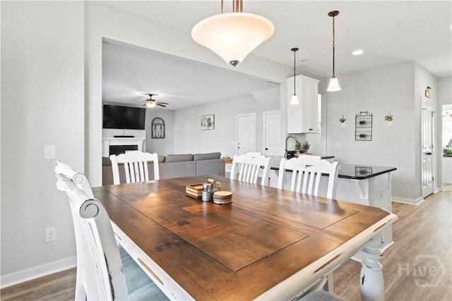 216 Cypress Lakes Dr, Bloomingdale, GA 31302 - dining space featuring ceiling fan, light wood finished floors, baseboards, a fireplace, and recessed lighting