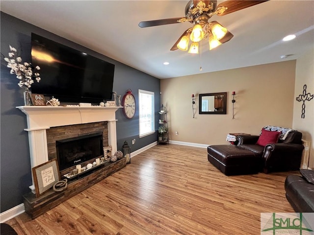 98 Vickers Rd SE, Ludowici, GA 31316 - living area with wood finished floors, ceiling fan, a stone fireplace, baseboards, and recessed lighting