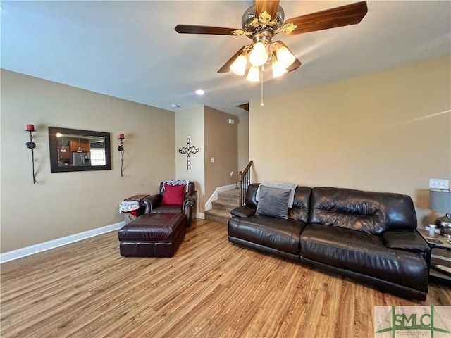 98 Vickers Rd SE, Ludowici, GA 31316 - living area with wood finished floors, a ceiling fan, baseboards, and stairway