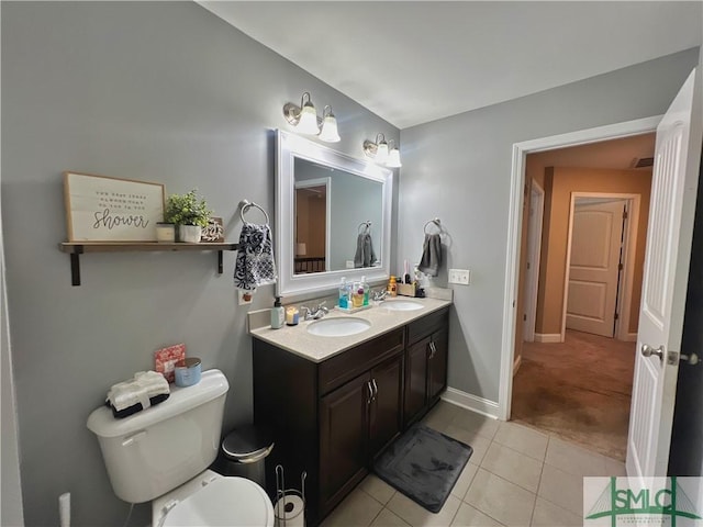 98 Vickers Rd SE, Ludowici, GA 31316 - bathroom with tile patterned floors, toilet, double vanity, and baseboards