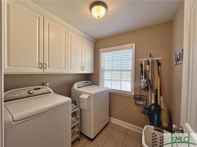 98 Vickers Rd SE, Ludowici, GA 31316 - laundry area featuring washer and dryer, cabinet space, light tile patterned floors, and baseboards