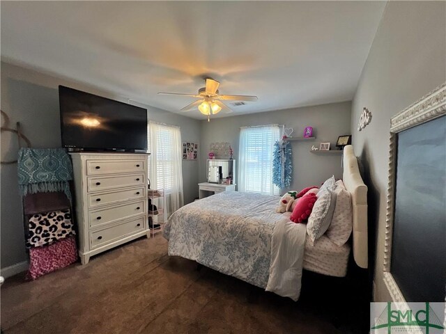 98 Vickers Rd SE, Ludowici, GA 31316 - bedroom with dark carpet and a ceiling fan