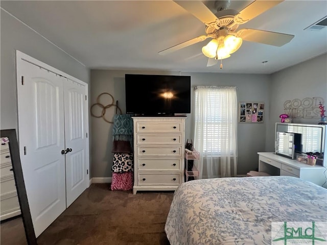98 Vickers Rd SE, Ludowici, GA 31316 - bedroom with dark colored carpet, a closet, a ceiling fan, and baseboards