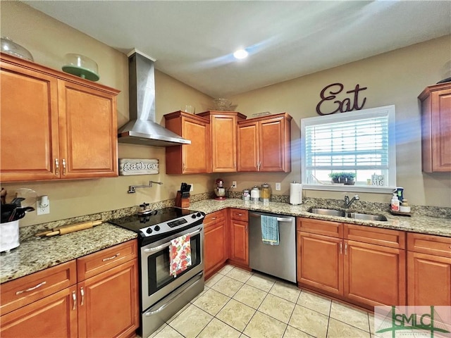 98 Vickers Rd SE, Ludowici, GA 31316 - kitchen featuring stainless steel appliances, wall chimney range hood, a sink, light tile patterned floors, and brown cabinetry