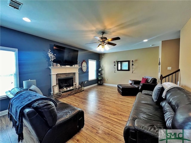 98 Vickers Rd SE, Ludowici, GA 31316 - living room with light wood-type flooring, ceiling fan, a fireplace with raised hearth, recessed lighting, and baseboards
