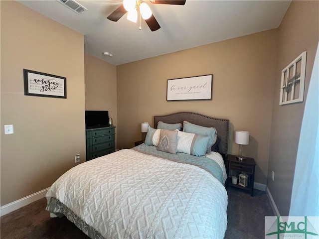 98 Vickers Rd SE, Ludowici, GA 31316 - bedroom with dark colored carpet, baseboards, and ceiling fan