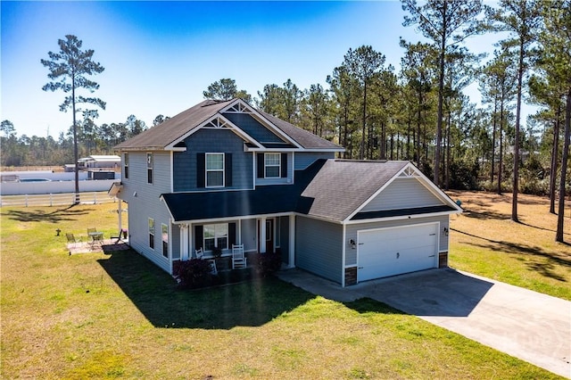 98 Vickers Rd SE, Ludowici, GA 31316 - craftsman-style house featuring covered porch, a garage, driveway, and a front lawn