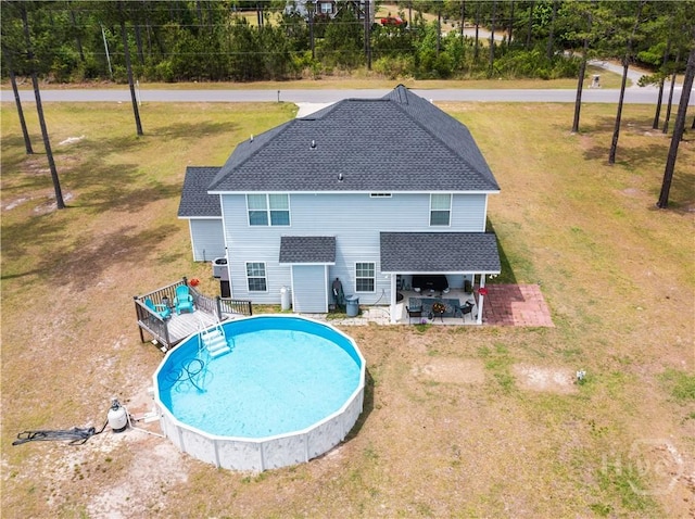 98 Vickers Rd SE, Ludowici, GA 31316 - view of pool featuring a wooden deck and a lawn