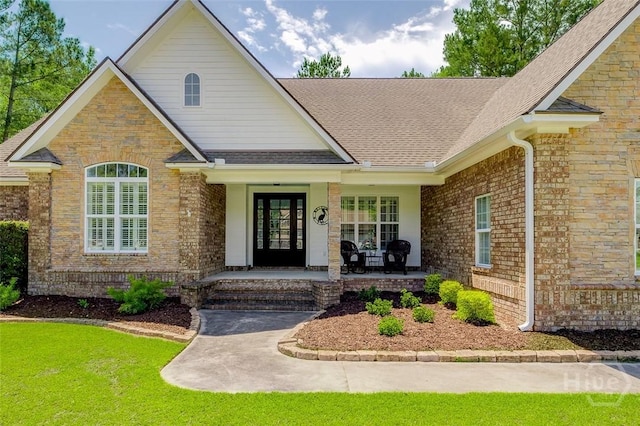 2 N Camellia Ct, Guyton, GA 31312 - view of front of property featuring a porch, roof with shingles, brick siding, and a front yard