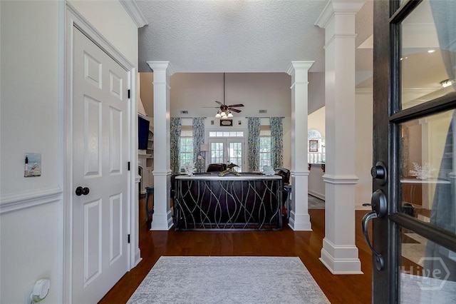 2 N Camellia Ct, Guyton, GA 31312 - entrance foyer with ornate columns, ceiling fan, dark wood-style floors, and a textured ceiling