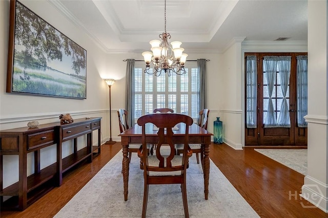 2 N Camellia Ct, Guyton, GA 31312 - dining room featuring a chandelier, dark wood finished floors, a raised ceiling, crown molding, and wainscoting