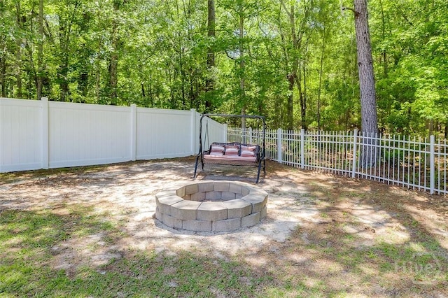 2 N Camellia Ct, Guyton, GA 31312 - view of yard featuring an outdoor fire pit, fence, a patio, and a wooded view