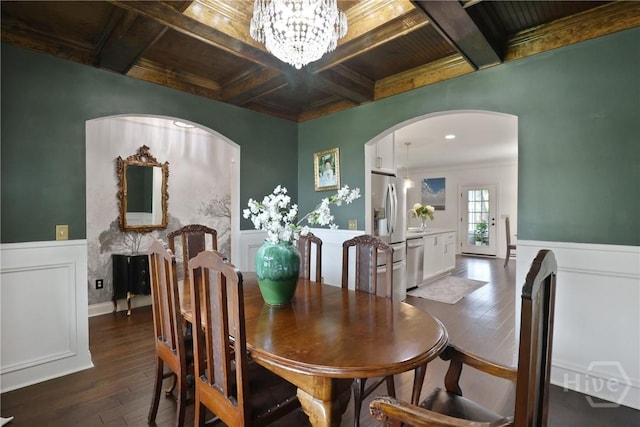 447 Walthour Dr, Rincon, GA 31326 - dining room with coffered ceiling, a chandelier, dark wood-style floors, a wainscoted wall, and arched walkways
