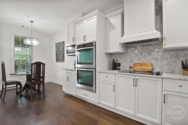 447 Walthour Dr, Rincon, GA 31326 - kitchen with stainless steel appliances, custom range hood, tasteful backsplash, white cabinetry, and crown molding