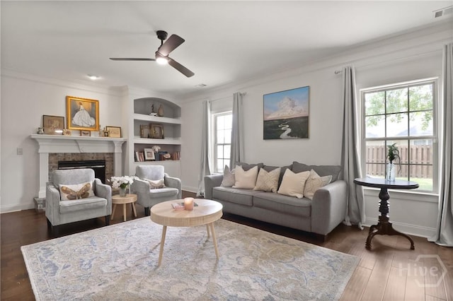 447 Walthour Dr, Rincon, GA 31326 - living area featuring healthy amount of natural light, crown molding, wood finished floors, a fireplace, and baseboards