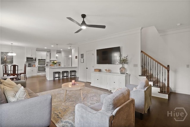 447 Walthour Dr, Rincon, GA 31326 - living room with dark wood-style floors, a ceiling fan, crown molding, and stairway
