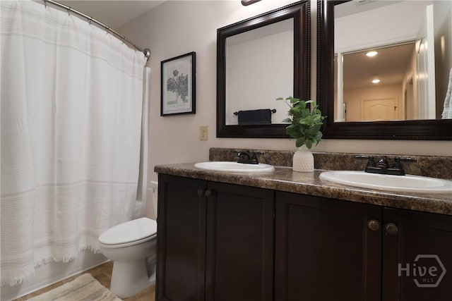 447 Walthour Dr, Rincon, GA 31326 - full bathroom with double vanity, toilet, shower / bath combo with shower curtain, and recessed lighting