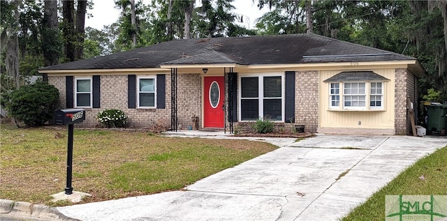 single story home with a front lawn, brick siding, driveway, and a shingled roof