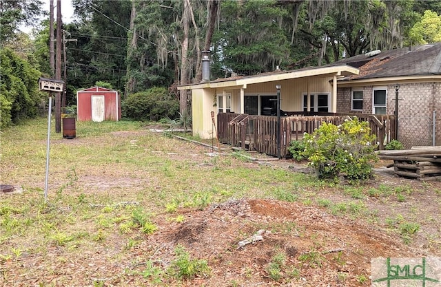 view of yard with a storage unit, an outdoor structure, and a wooden deck