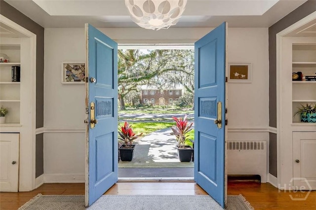 3600 Abercorn St, Savannah, GA 31405 - entrance foyer with radiator, wood finished floors, baseboards, and a chandelier
