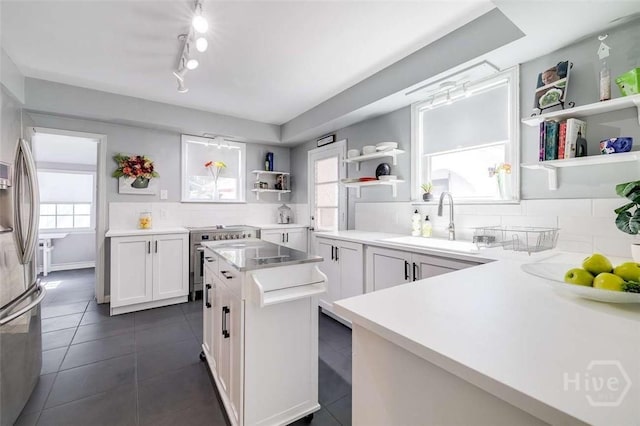3600 Abercorn St, Savannah, GA 31405 - kitchen with open shelves, plenty of natural light, stainless steel appliances, and white cabinets