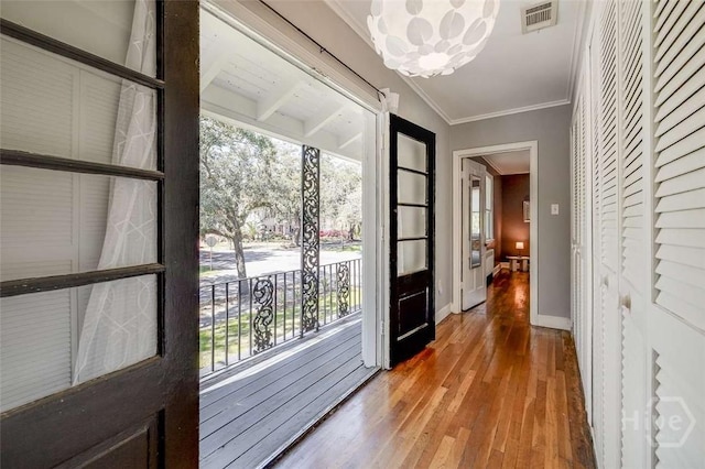 3600 Abercorn St, Savannah, GA 31405 - doorway to outside featuring wood-type flooring, ornamental molding, baseboards, and a chandelier