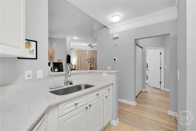 1733 Whitemarsh Way, Savannah, GA 31410 - kitchen with a sink, crown molding, white cabinets, a ceiling fan, and a peninsula