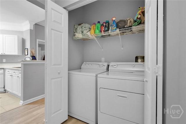 1733 Whitemarsh Way, Savannah, GA 31410 - clothes washing area with washing machine and clothes dryer, light wood-type flooring, and crown molding