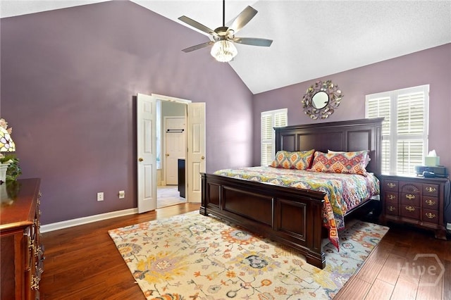 bedroom featuring multiple windows, wood finished floors, high vaulted ceiling, baseboards, and ceiling fan