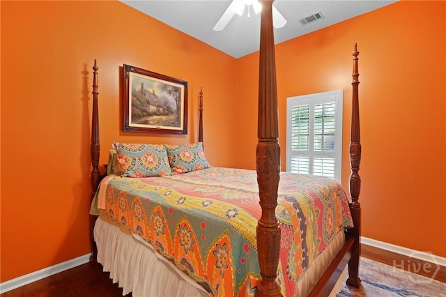 bedroom featuring baseboards, wood finished floors, and a ceiling fan