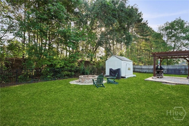 view of yard with an outdoor fire pit, a patio, a storage unit, a pergola, and an outdoor structure