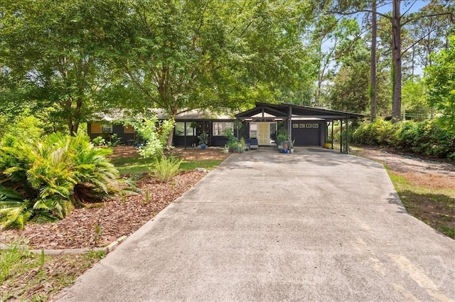 mid-century modern home with a carport and driveway