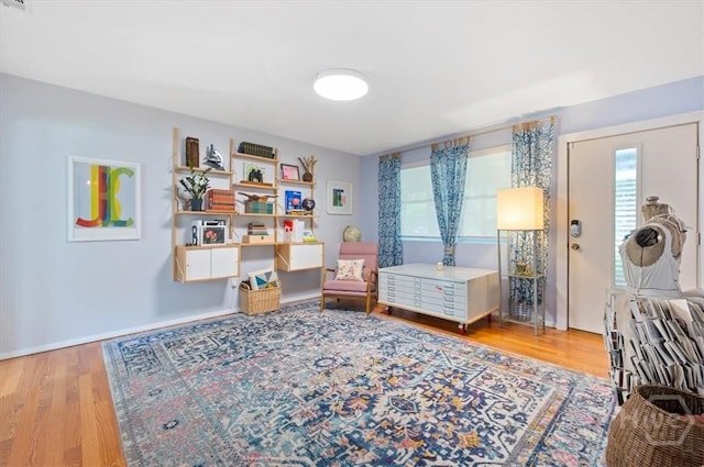 bedroom with multiple windows and wood finished floors