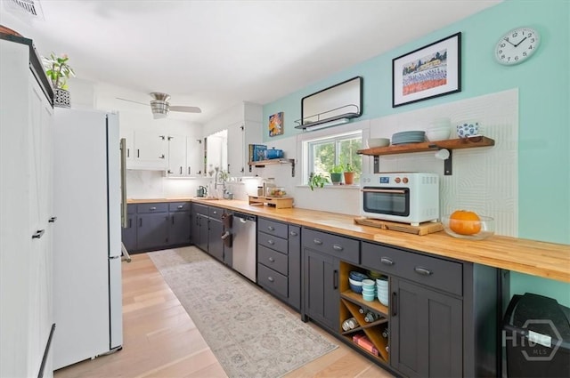 kitchen with open shelves, white appliances, gray cabinetry, and light wood-type flooring