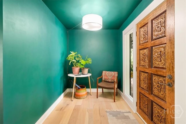 living area with wood finished floors and baseboards
