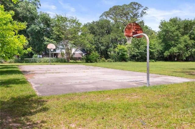 view of basketball court featuring community basketball court and a yard