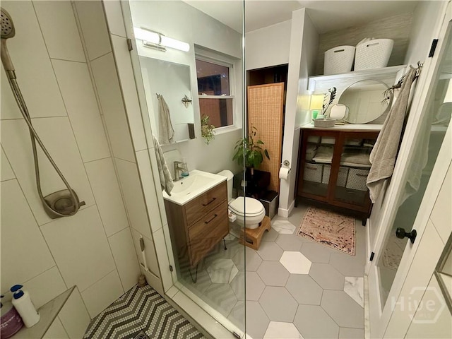 bathroom featuring vanity, tile patterned flooring, and toilet