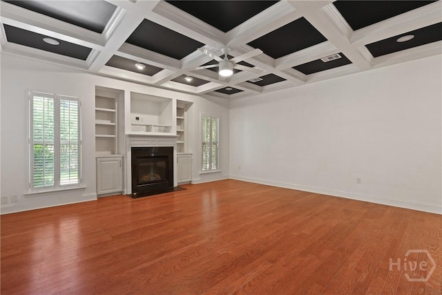 90 Golden Rod Loop, Richmond Hill, GA 31324 - unfurnished living room with light wood finished floors, beam ceiling, coffered ceiling, a ceiling fan, and a fireplace
