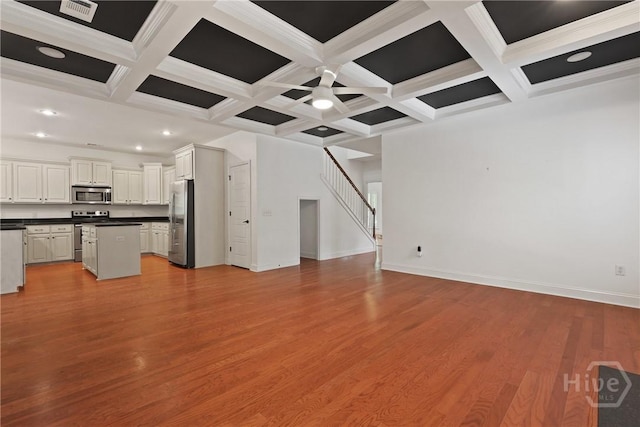 90 Golden Rod Loop, Richmond Hill, GA 31324 - unfurnished living room featuring recessed lighting, coffered ceiling, beam ceiling, baseboards, and light wood-type flooring