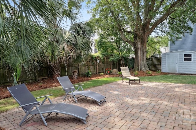 1212 2nd Ave, Tybee Island, GA 31328 - view of patio featuring a fenced backyard, a storage unit, and an outbuilding