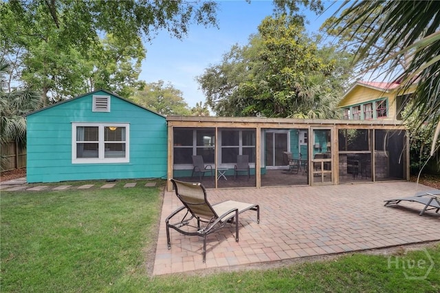 1212 2nd Ave, Tybee Island, GA 31328 - back of property with a patio, a lawn, and a sunroom