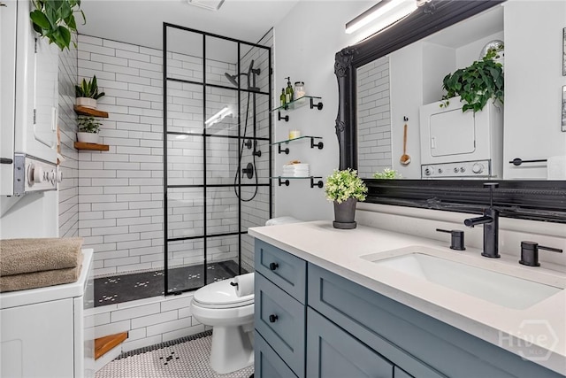 321 Abercorn St Unit 404, Savannah, GA 31401 - bathroom featuring stacked washer / dryer, a stall shower, toilet, vanity, and tile patterned flooring