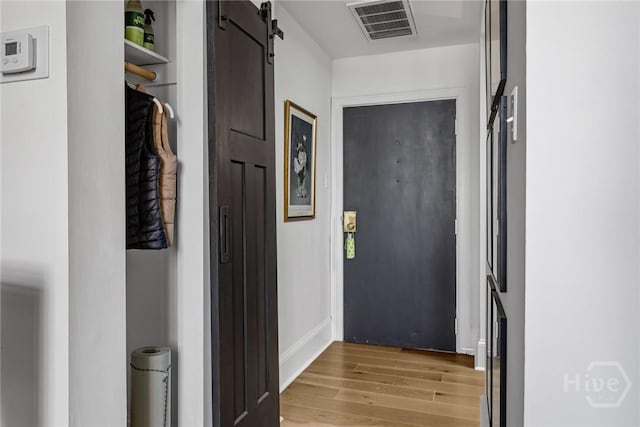 321 Abercorn St Unit 404, Savannah, GA 31401 - corridor with light wood-style flooring and a barn door