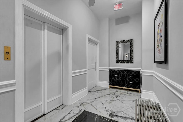 321 Abercorn St Unit 404, Savannah, GA 31401 - hall with marble finish flooring, elevator, and wainscoting